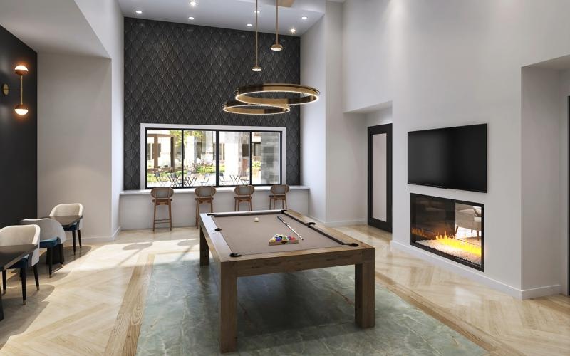 spacious lounge area with a pool table and a fireplace